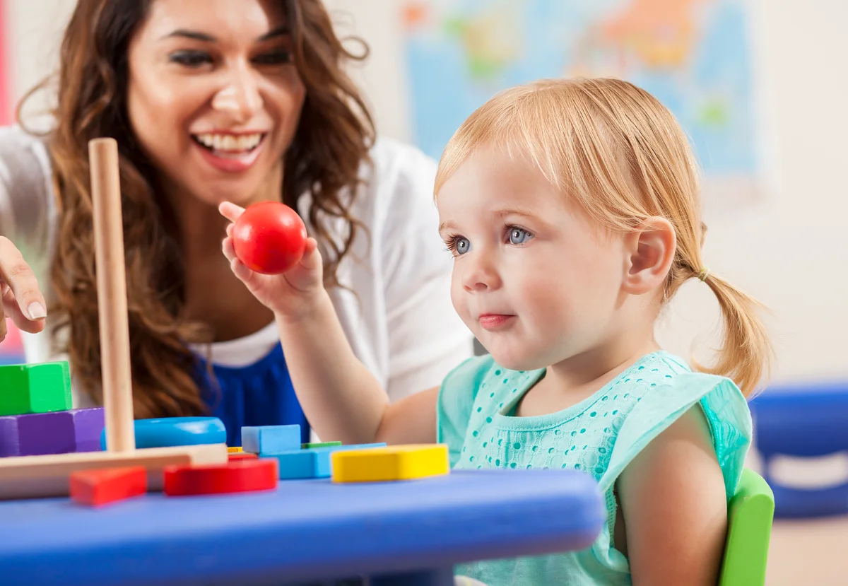 child playing with teacher
